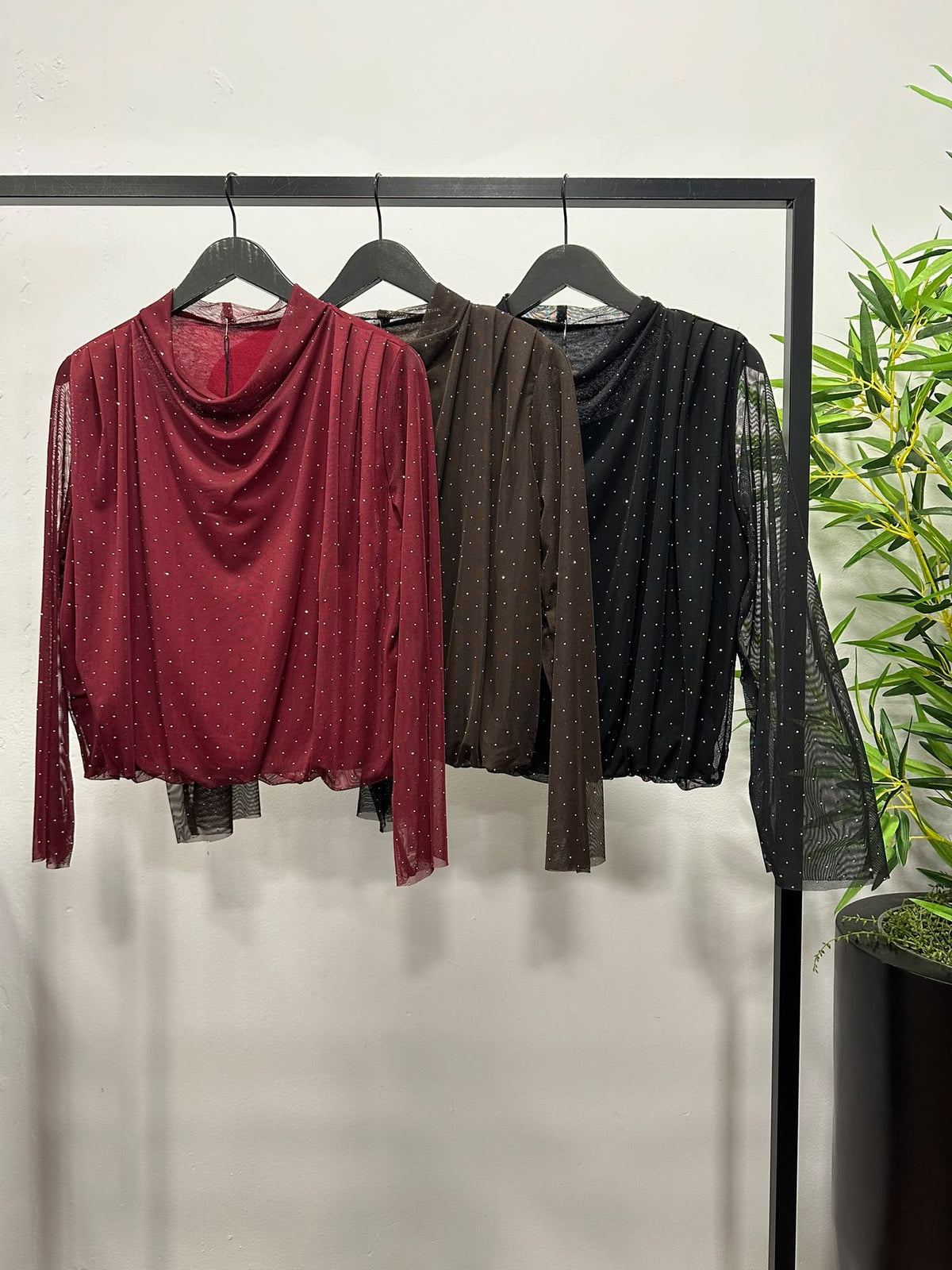Chastar tops in Bordeaux, Choco Bruin en Zwart met watervalhals, transparante mouwen en glinsterende details.