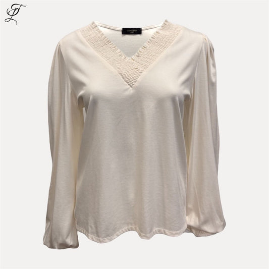 Trendy Leslie Chastar cream V-neck long sleeve top with pleated neckline and stretch fabric.