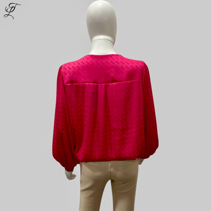 Chastar V-Hals Blouse in levendig fuchsia roze, gefotografeerd op een mannequin van achteren. De blouse toont een luchtige pasvorm met lange mouwen en elastische boorden, gemaakt van soepelvallende stof met subtiel ingeweven patroon. Collectie Blouses.