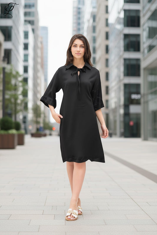 Trendy Leslie Chastar black lyocell midi dress with collar and tie detail, 3/4 sleeves, and pockets.
