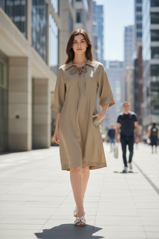 Trendy Leslie Chastar Lyocell dress with collar and lace-up detail, in a shimmering sand beige color.